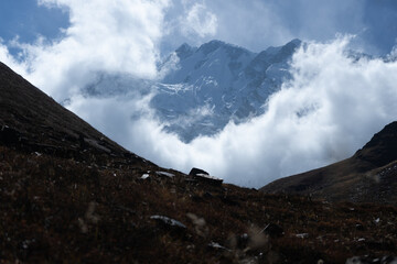 Majestic mountain partially veiled by clouds