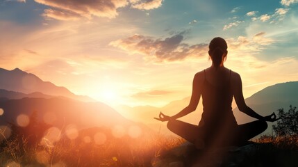 A woman is sitting in a field with the sun setting behind her