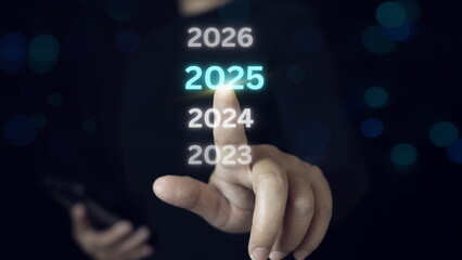 New year start concept. Businessman touch the number 2025 to change and enter the new year, merry christmas and happy new year.Businessman touching status bar to change from to 2025.