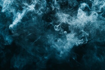 Obraz premium Dense and misty blue smoke forms intricate clouds swirling through the dark scene, presenting an ethereal and mysterious ambiance full of artistic depth.
