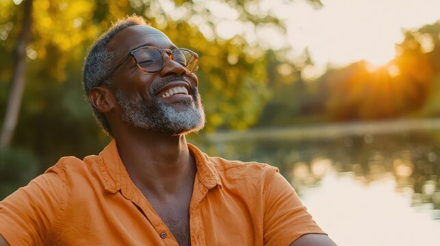 a joyful black man in his 50s radiating happiness amid a picturesque natural park near a lake, exuding confidence and relaxation, capturing the essence of a fulfilled life in nature