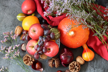 Autumn harvest. Carrots, apples, pumpkins, nuts on a table. Healthy diet concept. Seasonal fruit and vegetables close up. 