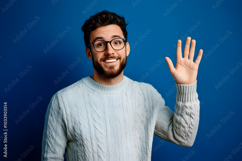 Sticker Young handsome man with beard wearing casual sweater and glasses over blue background Waiving saying hello happy and smiling, friendly welcome gesture