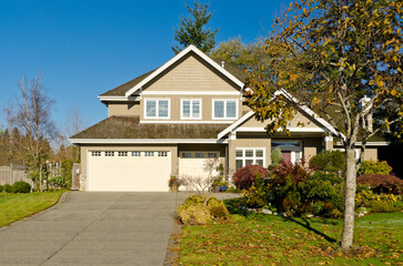 luxury house with garage door, big tree and nice Fall Foliage landscape in Vancouver, Canada