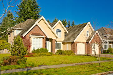 luxury house with garage door, big tree and nice Fall Foliage landscape in Vancouver, Canada