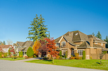 luxury house with garage door, big tree and nice Fall Foliage landscape in Vancouver, Canada