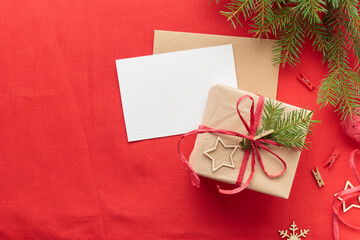 Christmas and zero waste, eco-friendly natural packaging gift in craft paper and a greeting card mockup on a wooden table, eco Christmas holiday concept, eco decor banner