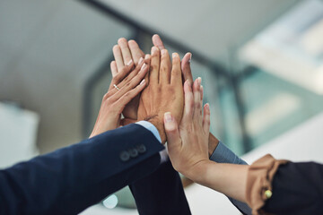 Business people, high five and motivation with team for meeting, collaboration or mission at office. Closeup, employees or group with hands together in huddle, solidarity or support for cooperation