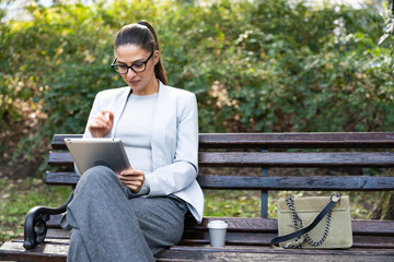 Obraz premium Tablet, business woman and research in city, typing or reading email notification to network. Digital, technology and professional agent in street on internet, communication or scroll on app outdoor