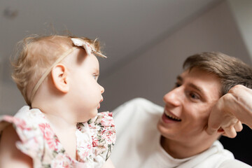 Father and young daughter sharing joyful moment, family connection. warm expressions and soft lighting emphasize nurturing atmosphere and strong parent-child bond.