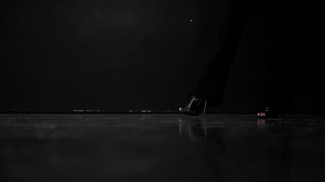 Dancer in high heels showcases salsa steps against a dark backdrop. Graceful movements and precise footwork create a captivating series of still images