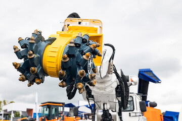 Truck with drilling head of mine roadheader. Concept underground mining of coal and ore