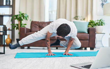 Fitness, crow pose and man with yoga in home for flexibility, mindfulness and wellness exercise. Challenge, balance and male person with kakasana position for pilates workout in living room at house.