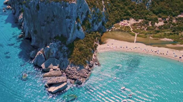 Best and most beautiful beaches of Sardinia island (Italy). Aerial panoramic drone view of white sandy beach, caves and turquoise sea. high angle 4khd video