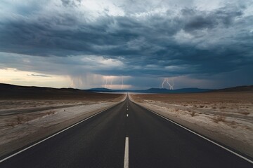 A long, straight road stretching out into the distance under a dramatic, stormy sky with dark clouds