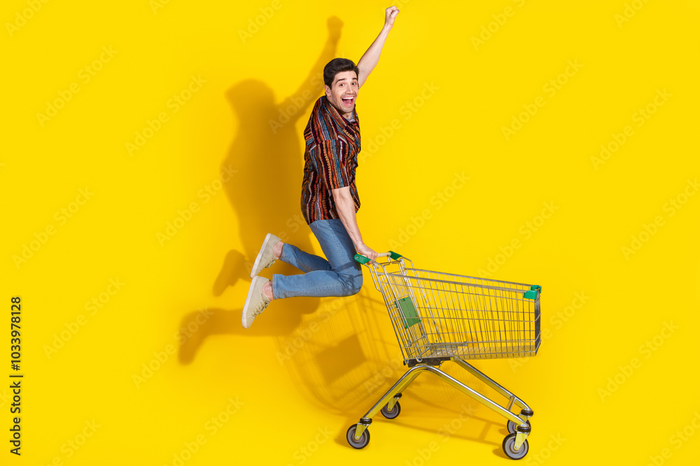 Canvas Prints Full length portrait of nice young man jump raise fist trolley wear shirt isolated on yellow color background