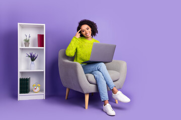 Full body photo of attractive young woman sit armchair minded office dressed stylish green clothes isolated on violet color background