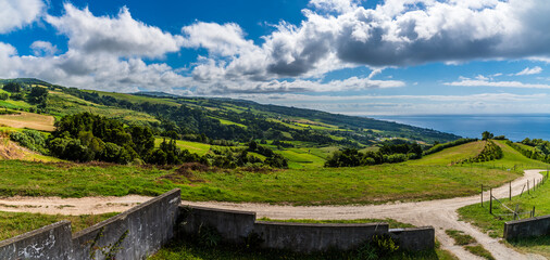 Fototapeta premium A view along the coast from the Chapel of Our Lady of Peace above Ribeira Seca on the island of San Miguel in the Azores in summertime