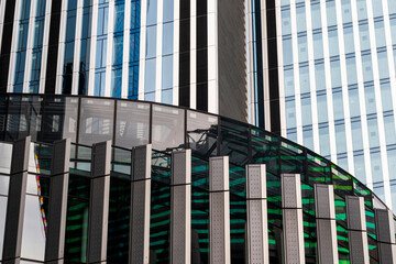 A modern facade featuring linear architectural patterns accented by vibrant colors, reflecting contemporary urban design trends and lively city energy.