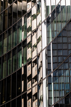 A close-up of a reflective facade showcasing complex urban architectural patterns, offering a glimpse into modern design principles and sophistication.