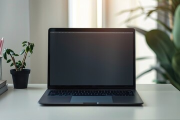 Fototapeta premium Laptop computer placed on a white desk, ideal for workspace or office settings
