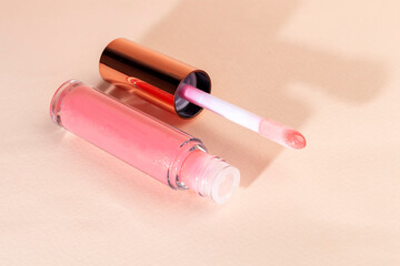 Lip gloss with applicator in light tubes. Cosmetic accessories.