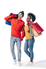 A happy couple celebrates the winter season with festive sweaters and holiday shopping bags in hand.