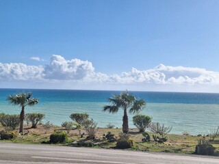 A scenic curved coastal road winding along the coastline. The perfect day for a journey, traveling. View of the cliffs and the bright turquoise sea. Beautiful landscape.