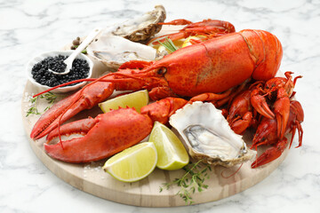 Many different sea food on white marble table, closeup