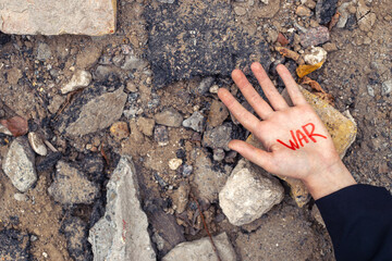 Slogan of peace without war is written on the woman's hand in red war.