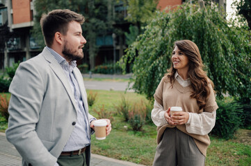Business people talking and holding coffee outside