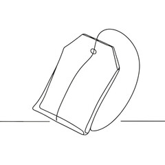 A tag is hanging from a tea bag. The tag is white and has a black border. The tea bag is sitting on a table