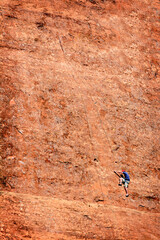 Rock Climber Tourist Climbing Sandstone Cliff for the First Time