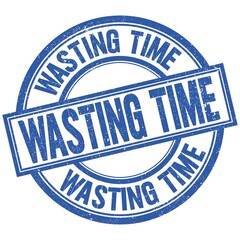 Fototapeta premium WASTING TIME written word on blue stamp sign