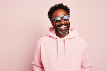 Obraz premium Portrait of a joyful afro-american man in his 40s wearing a thermal fleece pullover over pastel or soft colors background