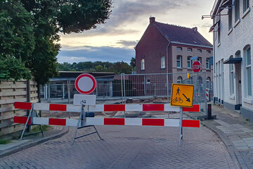 Street closed due to urban redevelopment works, no entrance sign, blocked road, security posts, exclusive access for pedestrians and cyclists, Beek, South Limburg, Netherlands