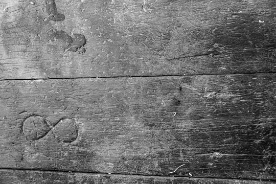 Grungy aged wood with textured black paint and rough surface, featuring a heart pattern, black and white