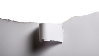 Torn white paper on a textured surface, revealing negative space for creative design.