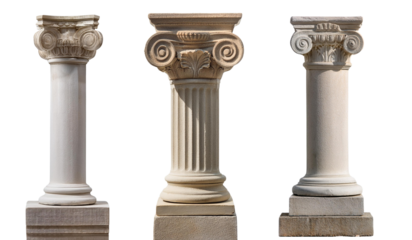 Three classical architectural columns with intricate designs against a white isolated background.