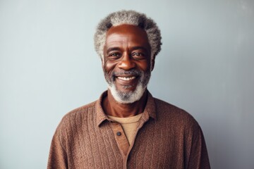 Obraz premium Portrait of a glad afro-american man in his 60s wearing a versatile buff while standing against minimalist or empty room background