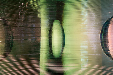 Artistic composition with the close-up of a glass structure on a reflective surface. The natural light illuminates and produces shine and beautiful shapes. creative and abstract background