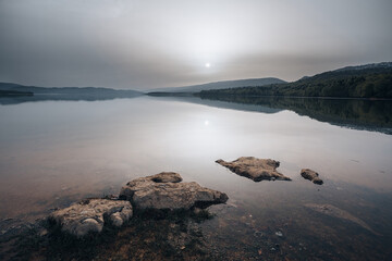 Sunrise on a mountain lake, cloudy weather, Shaori Reservoir Georgia