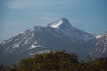 mountains covered with forest against the backdrop of snowy peaks, mountains of Georgia