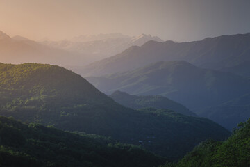 Obraz premium mountain ranges at sunset in the haze
