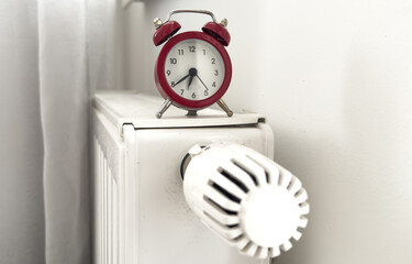 House heating inclusion concept. Battery clock to heat the room
