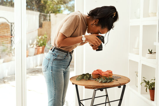 Cupcake, woman and camera for professional photography, creative art or presentation. Photographer, technology or picture of food in house for dessert blog, content creation or influencer film leaves