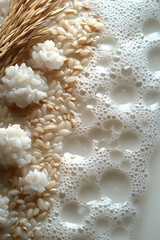 A close-up of textured foam, mixed grains, and rice arranged artistically against a soft, light background, conveying a sense of freshness and natural ingredients.