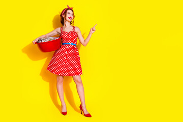 Photo of cute lovely adorable housemaid lady washing clothes tidy laundry empty space isolated on vivid yellow color background