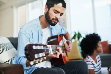 Man, music and passion with guitar at home for audio, production or hobby performance. Couple,...