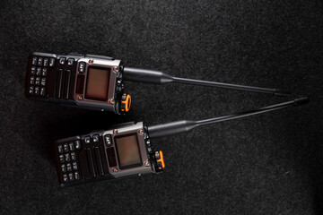 Radio system. Walkie-talkie. Two walkie-talkies. Antenna. Walkie-talkie in hands. Gray background. Minimalism. Product photo. Good photo quality